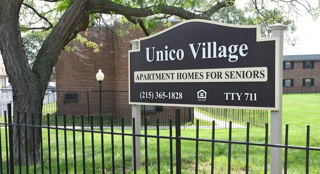 Unico Village Apartments sign
